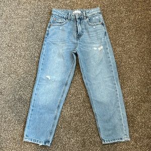 Zara girls mom fit jeans with ripped details in light blue denim.